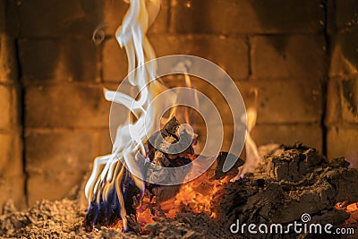 Home fireplace with beautiful orange fire and wood fire close. Burning fire in the fireplace. Logs on fire Stock Photo
