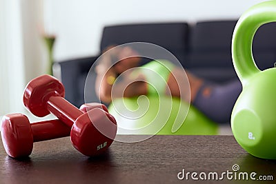 Home Fitness Red Weights On Table And Woman Training Abs Stock Photo