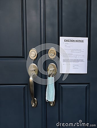 Home front door with eviction notice and facemask for renter in default during coronavirus pandemic Stock Photo