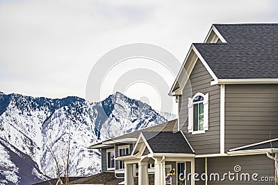 Home with gray exterior wall and stricking view of snowy mountain in winter Stock Photo