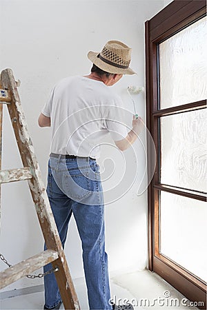 Home handyman or professional painter painting a room in his house Stock Photo