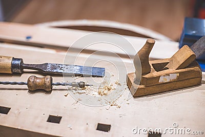 Home handyman using a plane for smoothing down a piece of timber Stock Photo