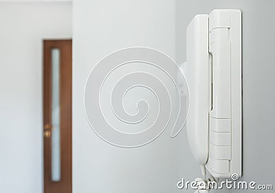 Home Intercom System Wired Talking Device on a Wall Stock Photo