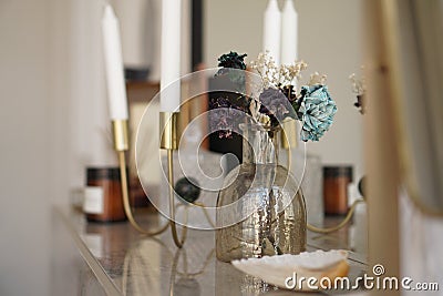 Home interior decor. Glass jar with dried flowers, vase and candle Stock Photo