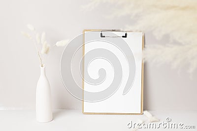 Home interior floral decor, pampas grass on table, Front view, clipboard, Greeting card Mockup. Beautiful white pampas grass in Stock Photo