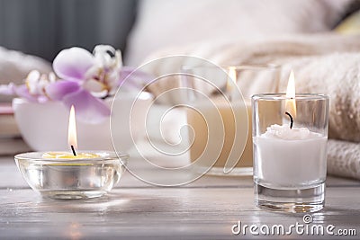 Home interior. Still life with detailes. Flower is vase, candles, on white wooden table, the concept of coziness Stock Photo