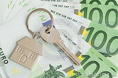 Home keys and a small house on currencies euro background Stock Photo