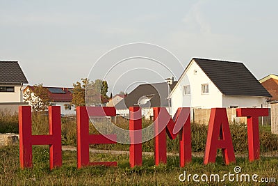 Home Letters in front of Houses Stock Photo