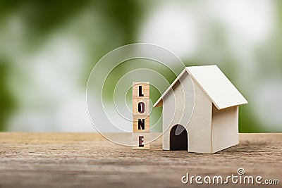 Home loan, mortgage, a property investment for future concept. A small residence house model and wooden block on wood table with Stock Photo