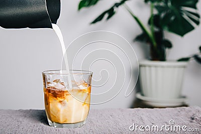 Home made coffee, pitcher Pour milk making latte coffee on table and coffee maker Stock Photo
