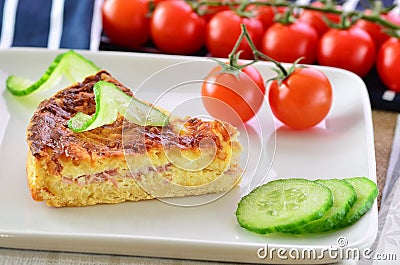 Home made ham and cheese quiche with tomatoes and cucumber Stock Photo