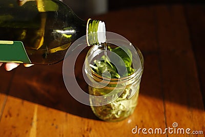 home made pesto basil oil for aroma therapy or cooking italian cuisine fresh homegrown healthy organic natural lifestyle basilico Stock Photo