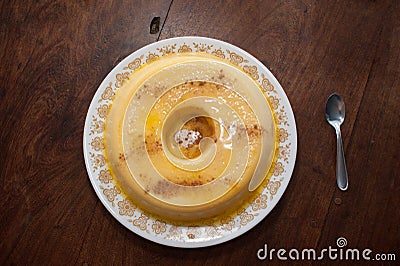 home made vanilla and cinnamon flan over a wooden table Stock Photo
