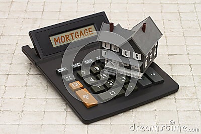 Home Mortgage, A gray house and calculator on stone background Stock Photo