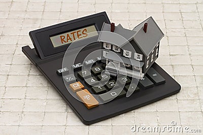 Home Mortgage Interest Rates, A gray house and calculator on stone background Stock Photo