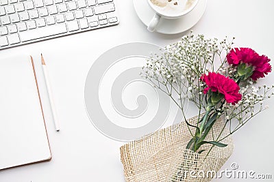 Home office desk table with notepad,flower bouquet Stock Photo