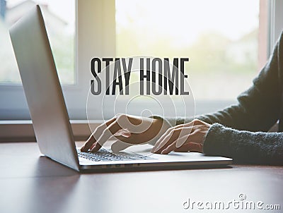Home office with freelancer hands with laptop and text Stay home Stock Photo