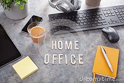 Home office text desk with keyboard computer smartphone notebook houseplants, working space at home Stock Photo