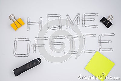 `Home office` written with metal paper clips on the white paper background. Flat lay. Stay home. Remote work. Remote education. Qu Stock Photo