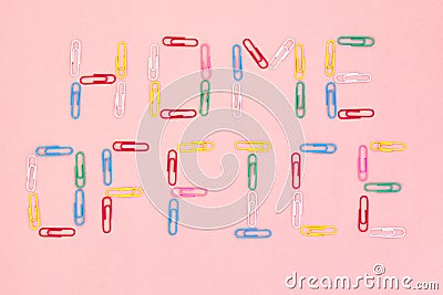 `Home office` written with multicolored paper clips on the pink paper background Stock Photo