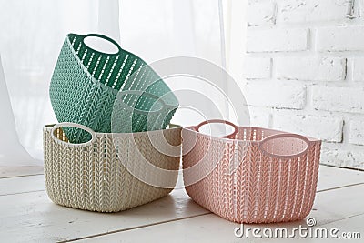 Home organizers colored baskets on white table Stock Photo