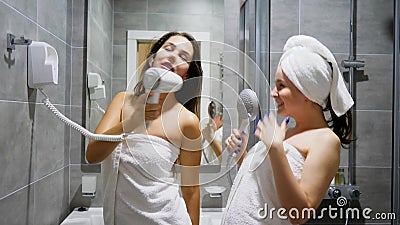 Home party girls, friends women dances and sing on background shower cabin and mirror at bathroom stock video footage Home party girls, friends women dances and sing on background shower cabin and mirror at bathroom stock video footage