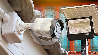 Home photovoltaic system including security camera and solar spotlight to provide safety for inhabitants Stock Photo