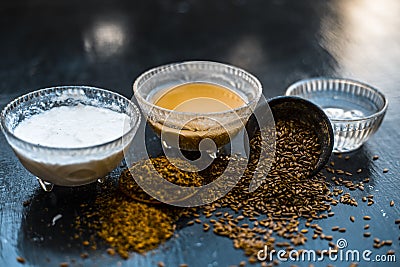 Home remedy for seborrhea dermatitis hair loss on wooden surface i.e. Curd with water and flax seed powder in a glass container wi Stock Photo