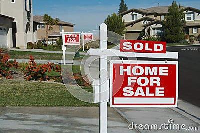 Home For Sale Signs & One Sold Stock Photo