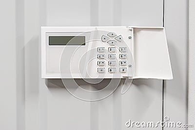 home security alarm on white wall security Stock Photo