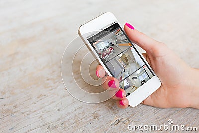 Home security cameras viewed on mobile phone Stock Photo