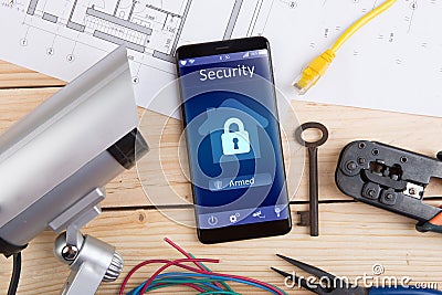 Home security concept smartphone with smart home app and surveillance cctv camera on the desk Stock Photo