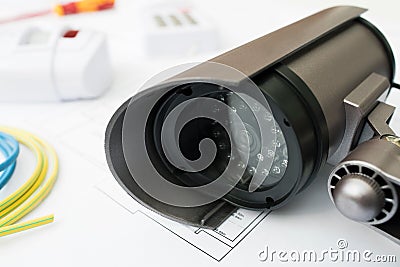 Still Life Of Home Security Products Arranged On House Plans Stock Photo