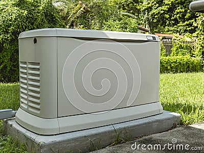 A Home Standby Generator installed at the backyard of a house. An air-cooled natural gas or liquid propane generator for Stock Photo