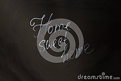 Home Sweet Home inscription on black background Stock Photo