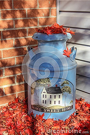 Home Sweet Home Welcoming Milk Can Covered With Fallen Leaves Stock Photo