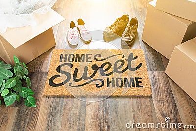 Home Sweet Home Welcome Mat, Moving Boxes, Female and Male Shoes Stock Photo