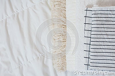 home textiles Flatlay. A stack of towels lies on a white bed Stock Photo