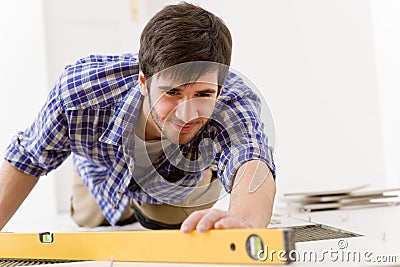 Home tile improvement - handyman with level Stock Photo