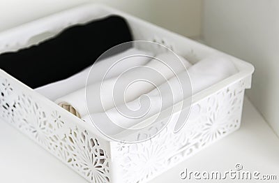 Home wardrobe with different clothes. Small space organization. Vertical storage Stock Photo