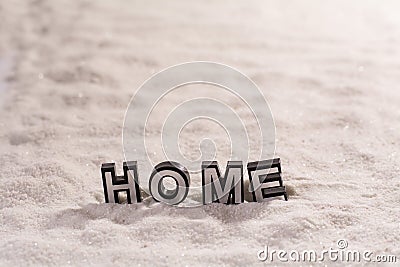 Home word on white sand Stock Photo