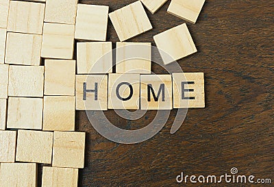Home word on wood plate abstract background. Stock Photo