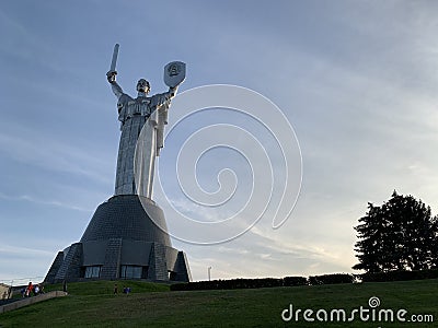 Homeland, high sculpture of a woman. Metal monument against the blue sky. Concept: sights of Kiev Editorial Stock Photo