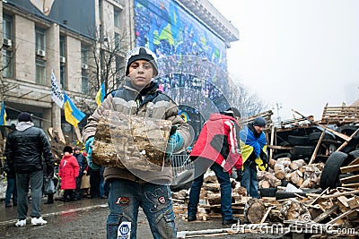 Homeless boy collect firewood outdoor Editorial Stock Photo