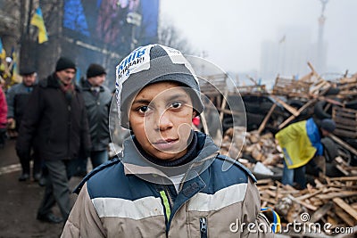 Homeless boy play on the cold street Editorial Stock Photo