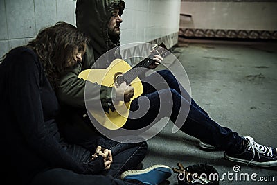 Homeless Couple Man Playing Guitar Asking For Money Donation Stock Photo