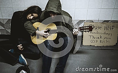 Homeless Couple Man Playing Guitar Asking For Money Donation Stock Photo