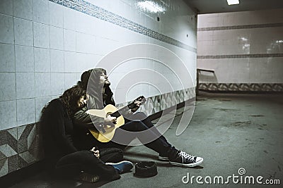 Homeless Couple Man Playing Guitar Asking For Money Donation Stock Photo