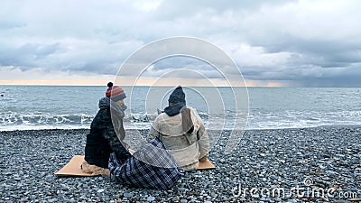 Homeless couple, man and woman, staying overnight by the sea Stock Photo