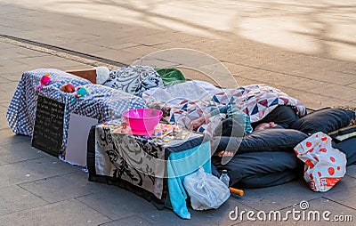 Homeless couple sleeping on the street Editorial Stock Photo